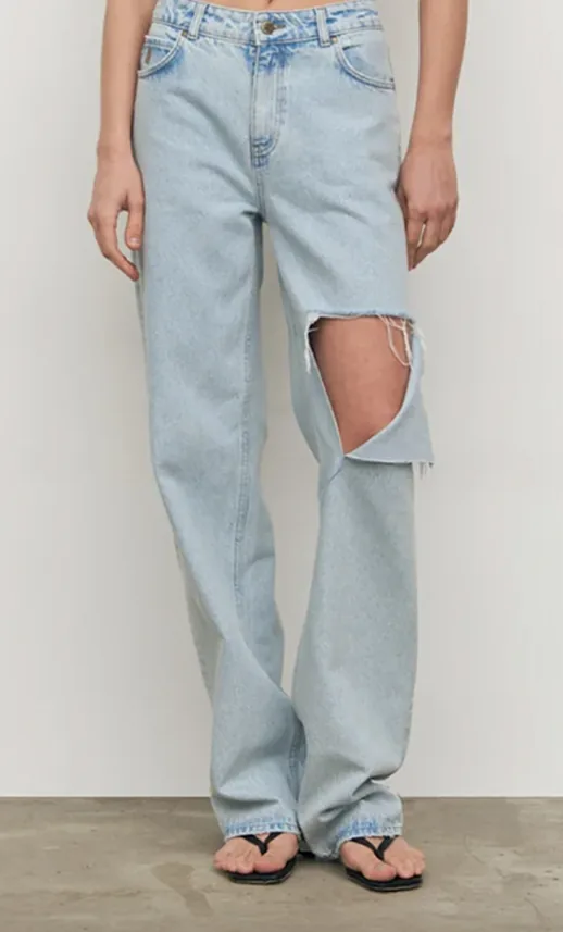 Light bleach-wash wide-leg jeans with a ripped knee